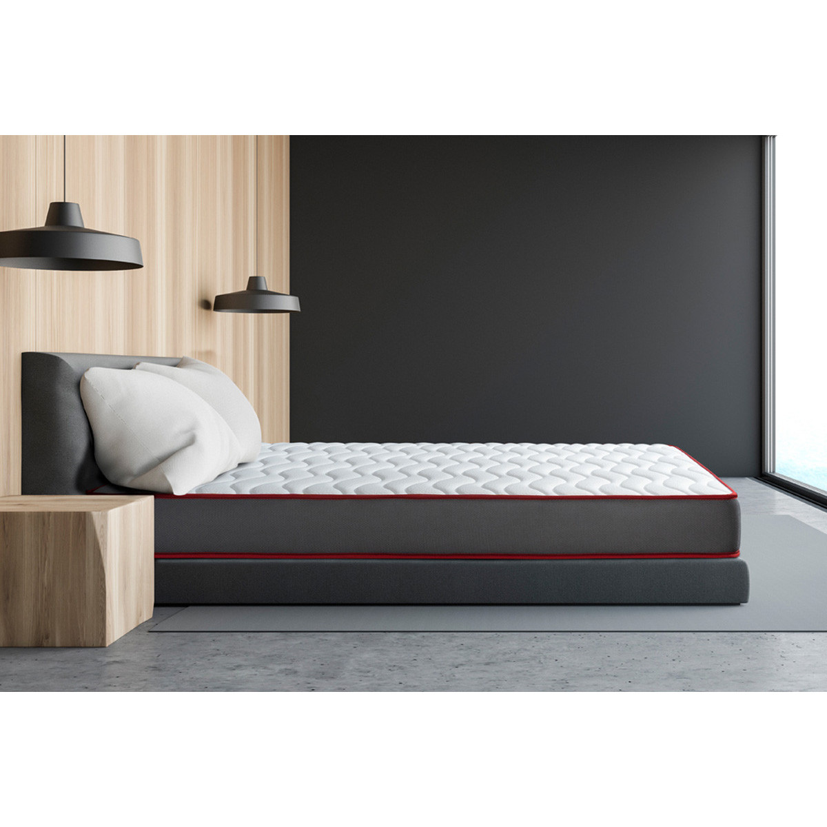 Vista lateral del colchón beloBed Comfortfusion gris con vivo rojo en un dormitorio